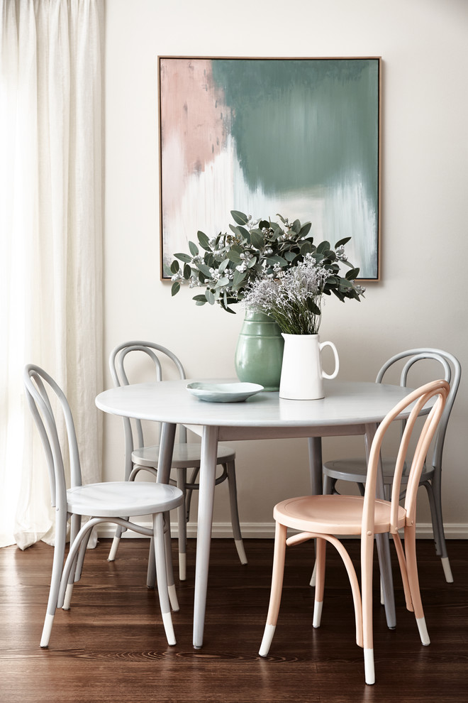 Transitional dining room in Melbourne with beige walls, dark hardwood floors and brown floor.