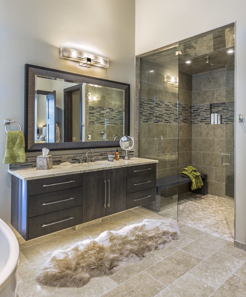 Inspiration for a country master bathroom in Philadelphia with flat-panel cabinets, dark wood cabinets, an alcove shower, beige tile, multi-coloured tile, matchstick tile, beige walls, an undermount sink, beige floor, a hinged shower door and beige benchtops.