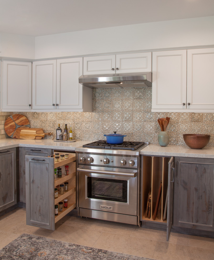 Inspiration for a mid-sized transitional u-shaped eat-in kitchen in San Diego with an undermount sink, shaker cabinets, distressed cabinets, quartz benchtops, blue splashback, ceramic splashback, stainless steel appliances, porcelain floors, a peninsula, white floor and white benchtop.