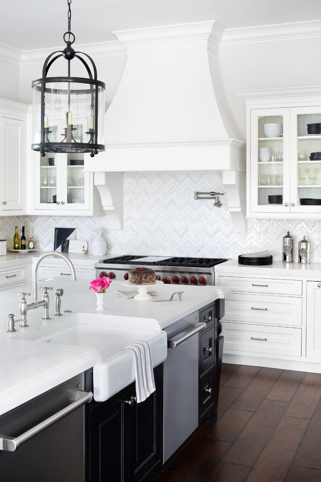 Inspiration for a traditional l-shaped kitchen in Miami with white cabinets, stainless steel appliances, with island, brown floor, a farmhouse sink, multi-coloured splashback, dark hardwood floors and beaded inset cabinets.