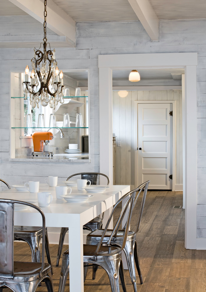 This is an example of an eclectic dining room in Seattle with white walls and dark hardwood floors.