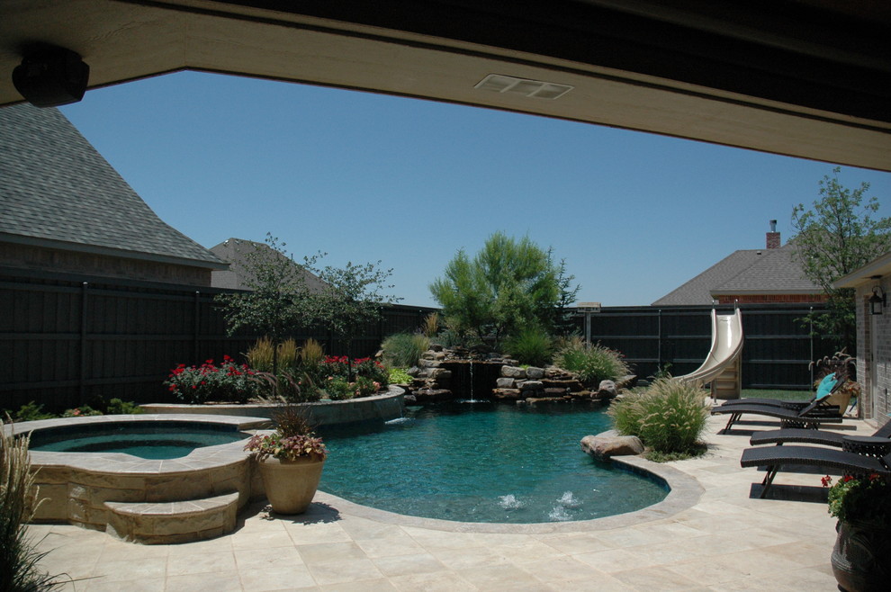 Example of a large mountain style courtyard stone and custom-shaped natural hot tub design in Austin