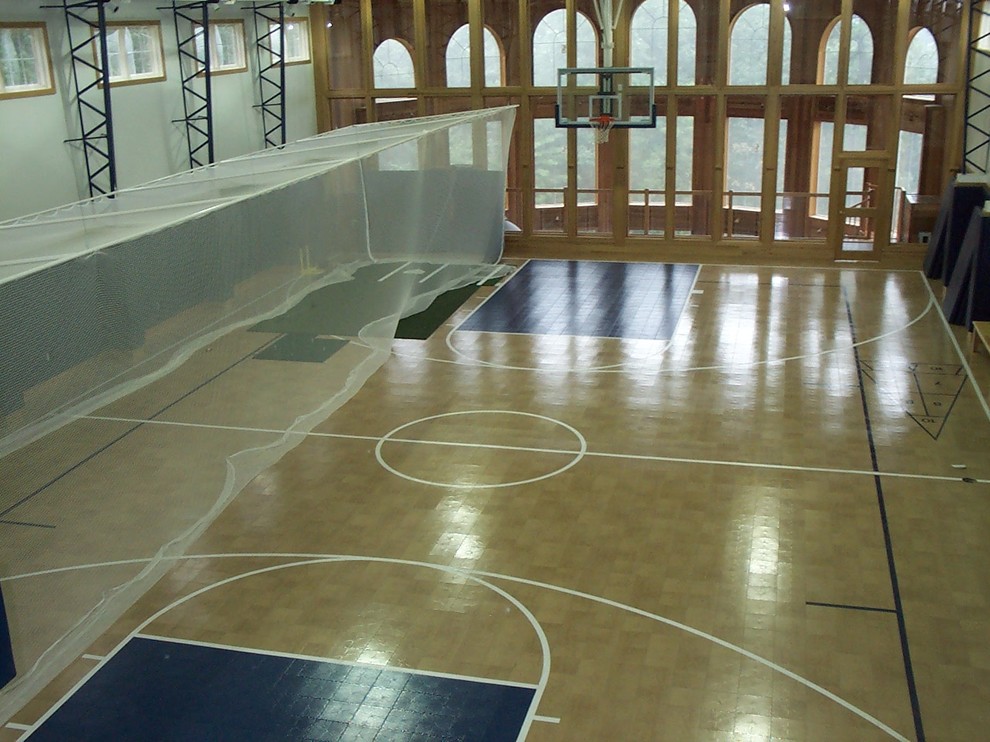 Design ideas for a mid-sized traditional indoor sport court in Boston with beige walls and light hardwood floors.