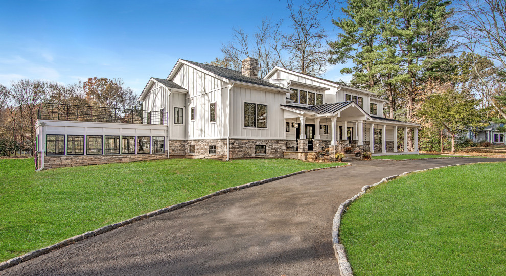 Large cottage white two-story concrete fiberboard exterior home idea in New York with a mixed material roof