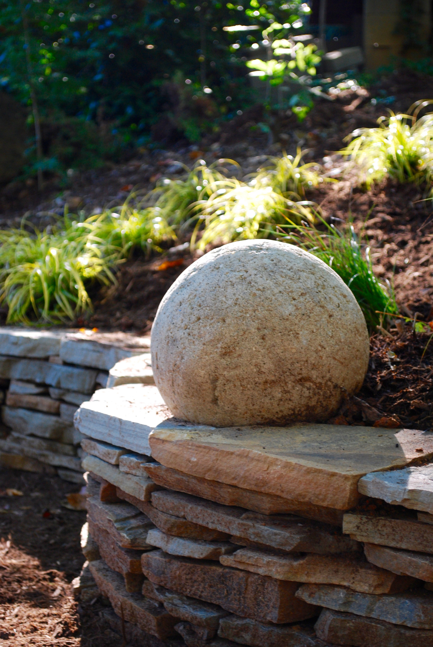 Stone sphere and serpentine wall.