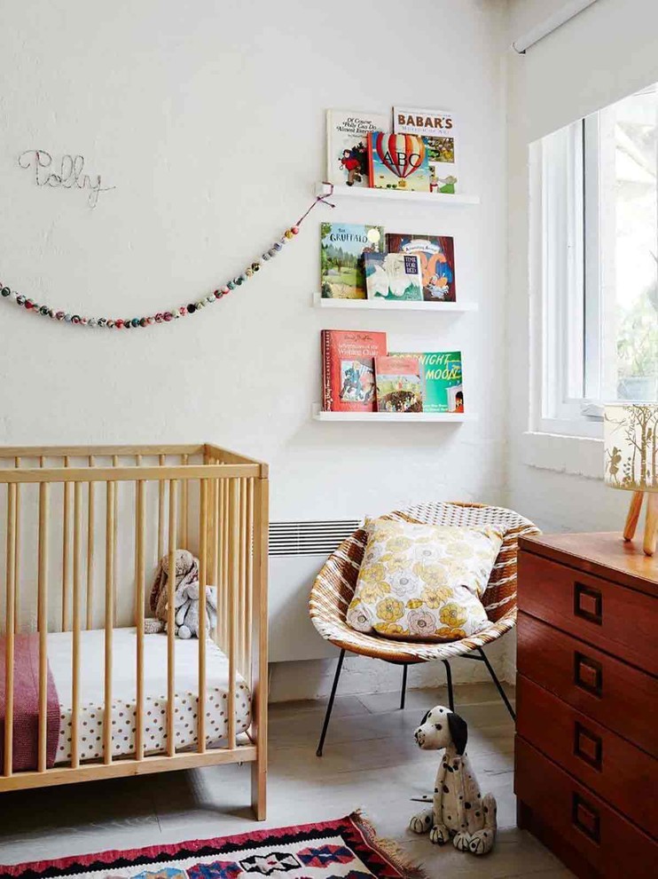 This is an example of a transitional nursery in Melbourne with white walls and grey floor.