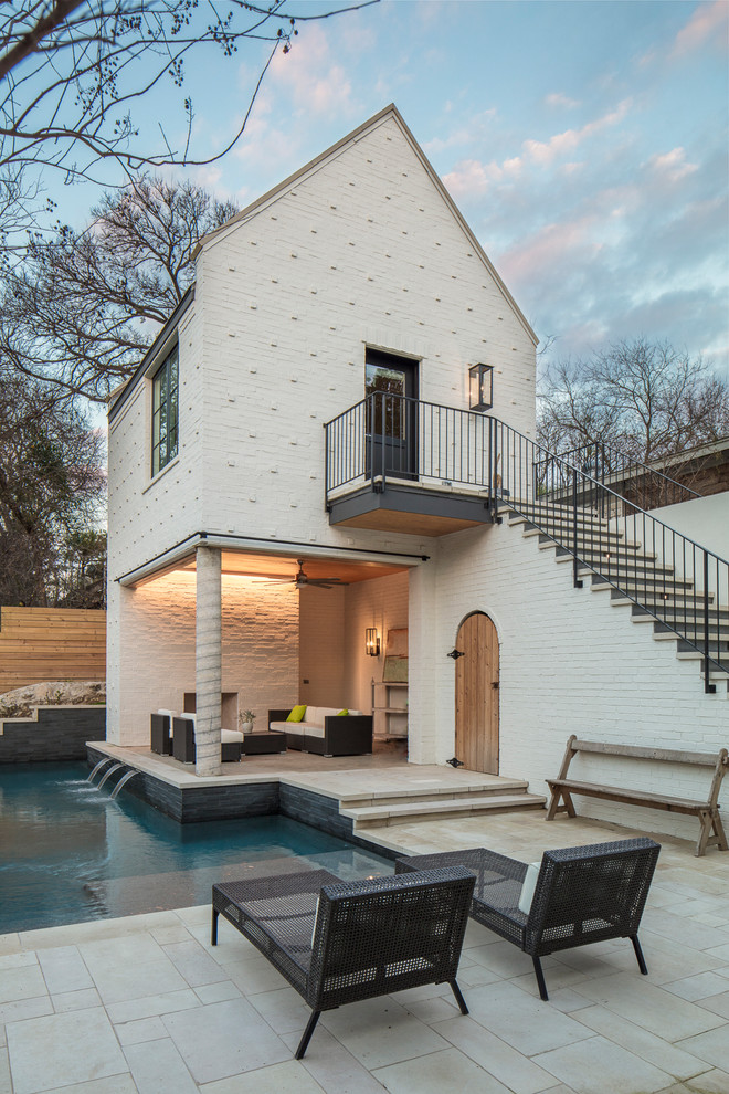 Inspiration for a transitional l-shaped pool in Austin with a pool house.