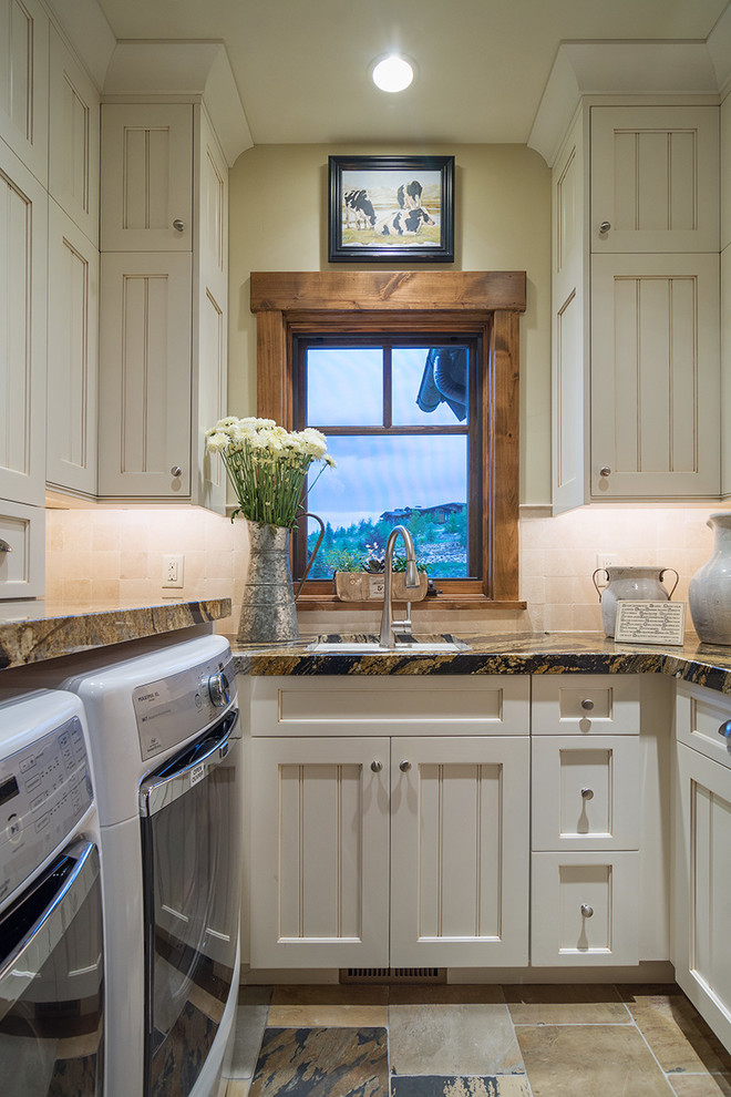 This is an example of a mid-sized country u-shaped dedicated laundry room in Salt Lake City with an undermount sink, recessed-panel cabinets, beige cabinets, beige walls and a side-by-side washer and dryer.