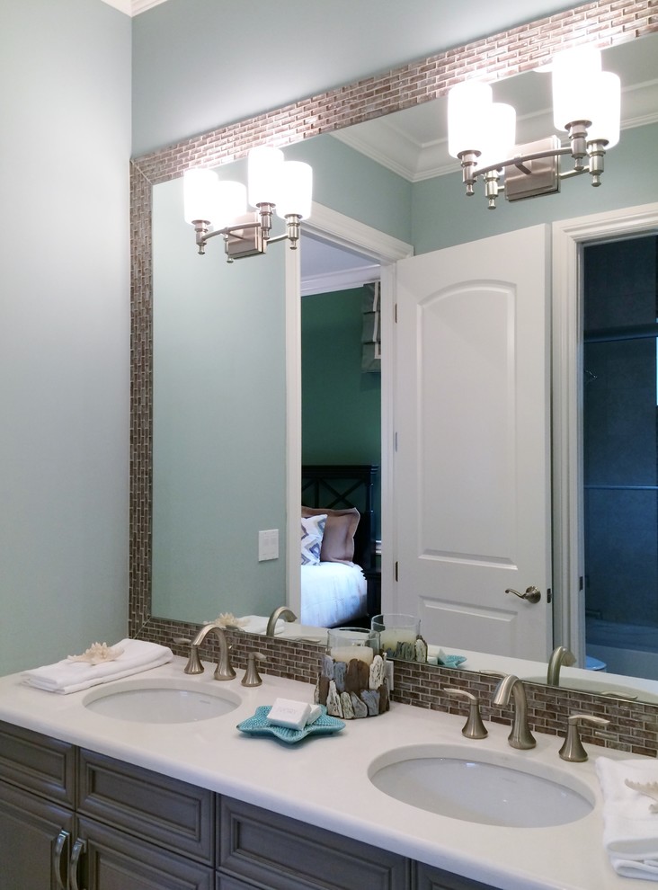 Example of a small transitional 3/4 multicolored tile and glass tile porcelain tile home design design in Tampa with an undermount sink, raised-panel cabinets, gray cabinets, recycled glass countertops, a one-piece toilet and blue walls