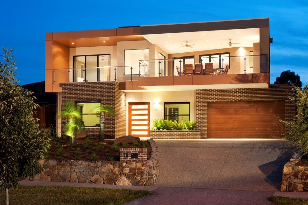 Inspiration for a contemporary two-storey exterior in Melbourne with mixed siding.