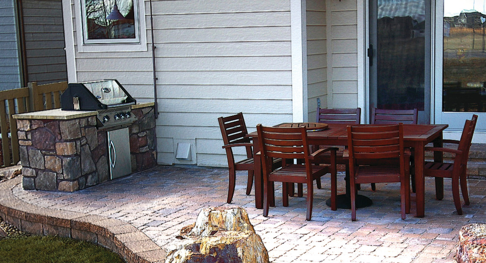 Mid-sized backyard concrete paver patio photo in Denver with a fire pit and no cover