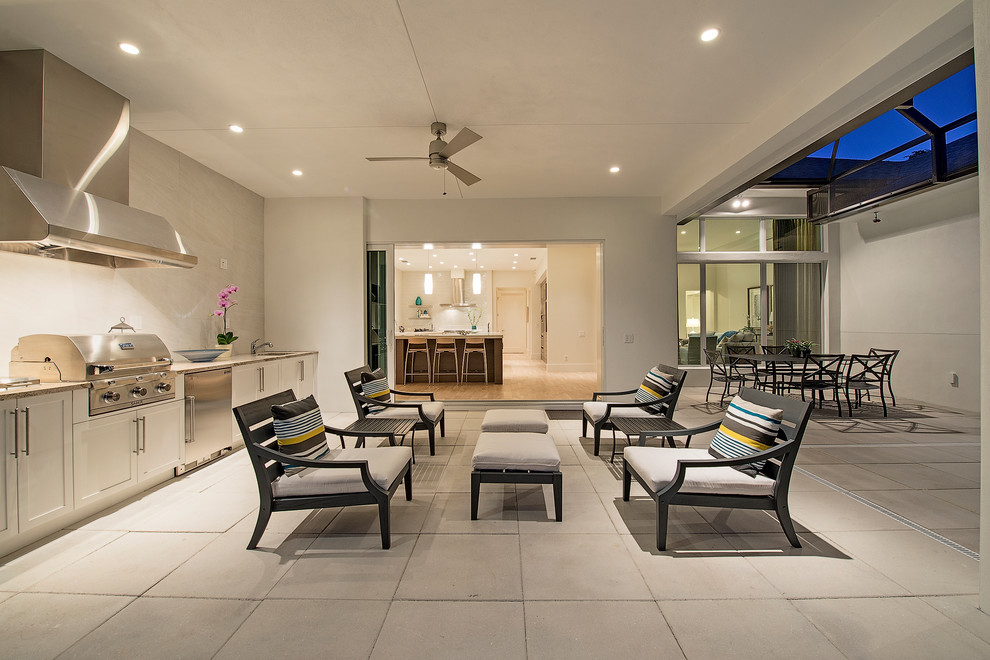 Design ideas for a transitional backyard patio in Miami with a roof extension.