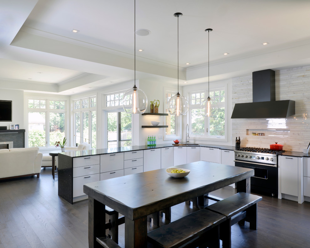 Inspiration for a large transitional u-shaped open plan kitchen in Toronto with flat-panel cabinets, white splashback, a double-bowl sink, stainless steel appliances, dark hardwood floors and a peninsula.