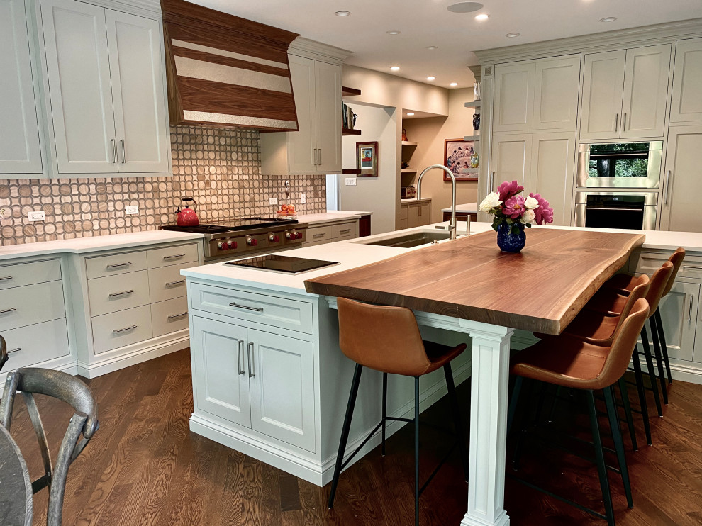 Huge transitional l-shaped medium tone wood floor and brown floor eat-in kitchen photo in Chicago with an undermount sink, flat-panel cabinets, white cabinets, quartzite countertops, beige backsplash, glass tile backsplash, stainless steel appliances, an island and white countertops