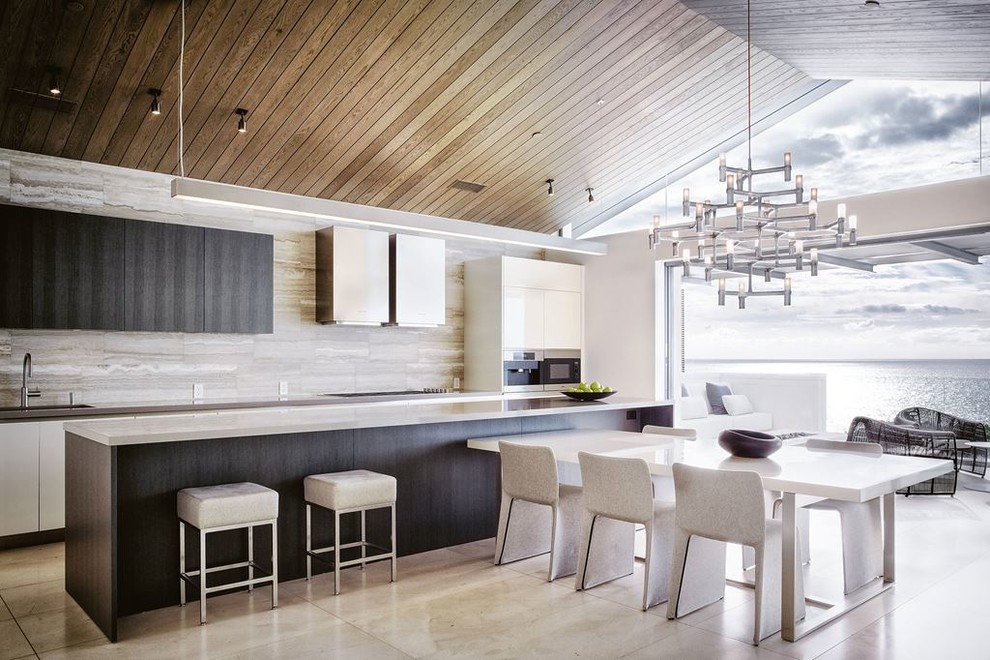 Design ideas for a mid-sized modern galley open plan kitchen in San Francisco with an undermount sink, flat-panel cabinets, dark wood cabinets, zinc benchtops, brown splashback, stone tile splashback, stainless steel appliances, travertine floors and with island.