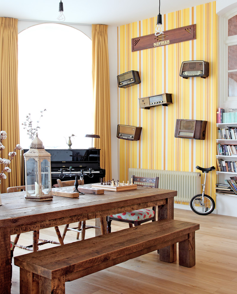 Design ideas for a large eclectic dining room in London with yellow walls.