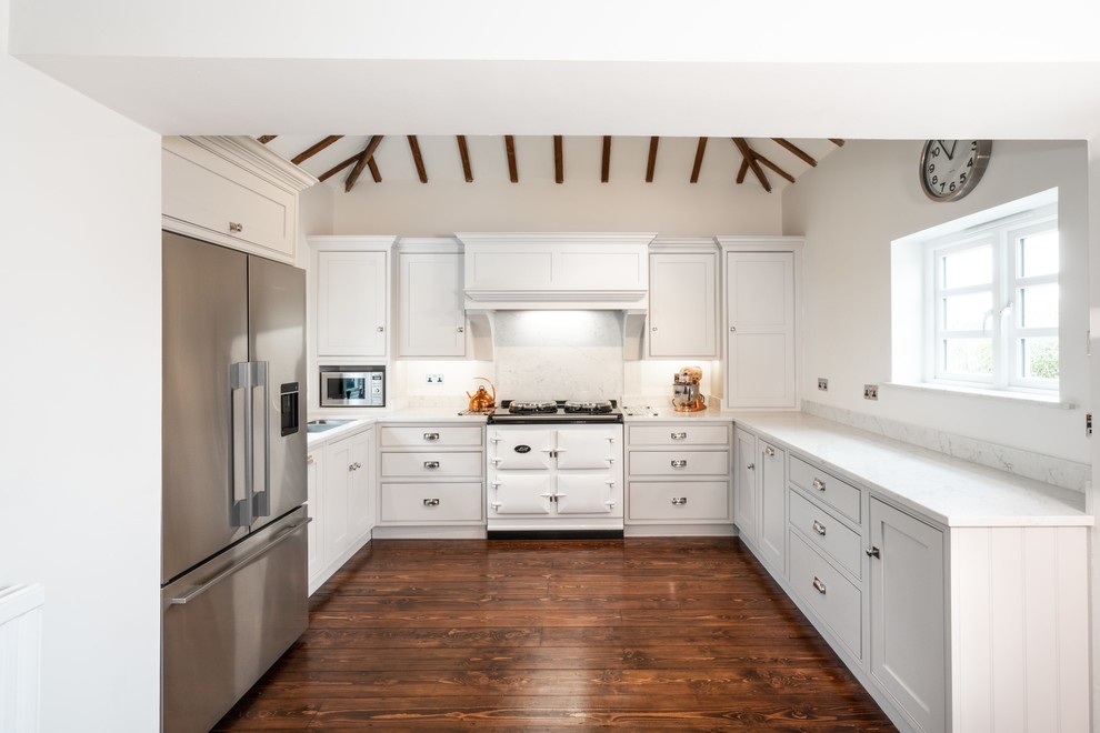 Inspiration for a small transitional u-shaped eat-in kitchen in Essex with recessed-panel cabinets, white cabinets, quartzite benchtops, white splashback, marble splashback and white benchtop.