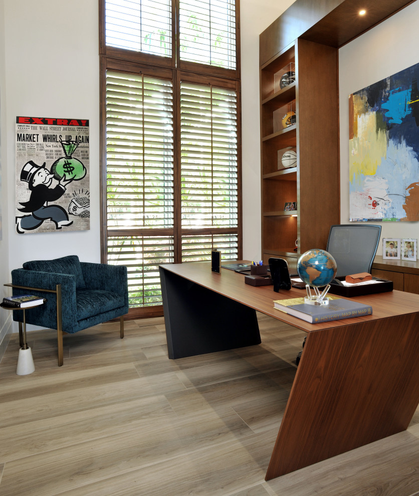 Inspiration for a contemporary study room in Miami with porcelain floors, a freestanding desk and brown floor.