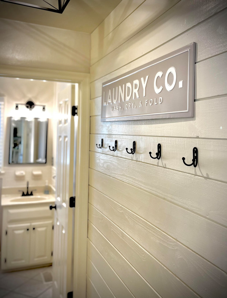 Photo of a small country laundry room in Other with planked wall panelling.