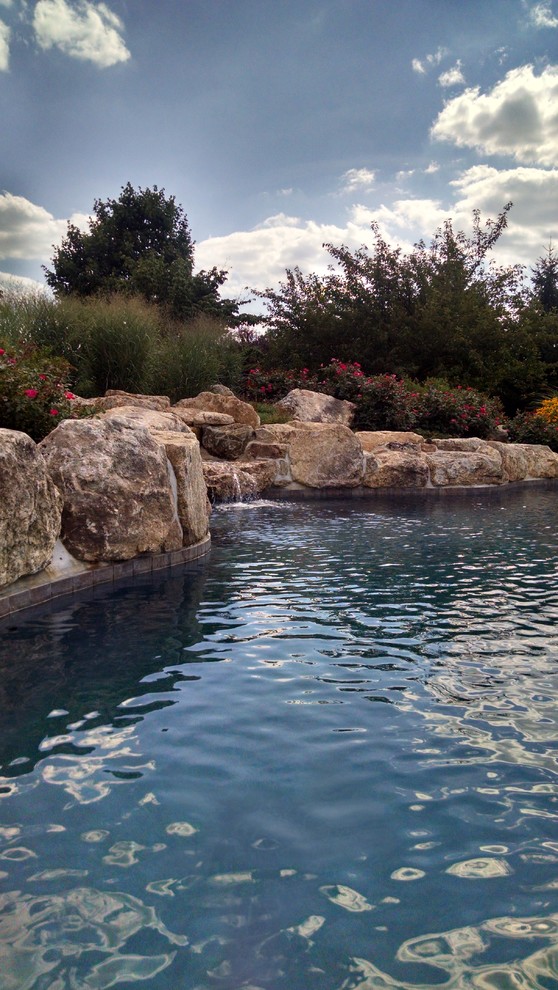 Pool - large rustic backyard custom-shaped natural pool idea in New York