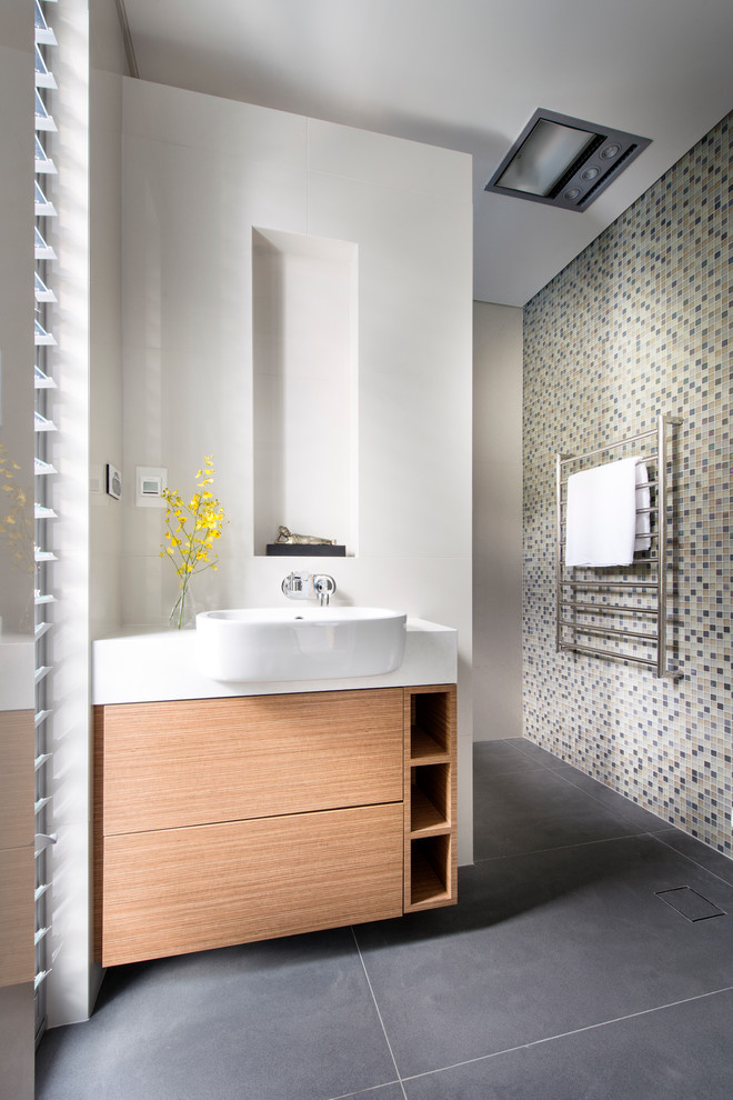 Inspiration for a mid-sized contemporary bathroom in Perth with flat-panel cabinets, medium wood cabinets, white walls, multi-coloured tile and mosaic tile.