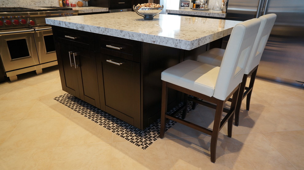 Kitchen - transitional l-shaped porcelain tile and beige floor kitchen idea in Phoenix with an undermount sink, recessed-panel cabinets, dark wood cabinets, quartz countertops, white backsplash, ceramic backsplash, stainless steel appliances and an island