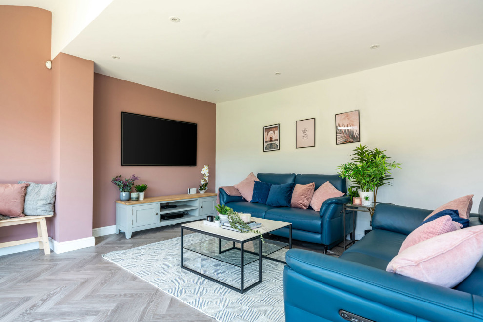 This is an example of a medium sized modern grey and pink open plan living room feature wall in West Midlands with grey walls, vinyl flooring, no fireplace, a wall mounted tv and grey floors.