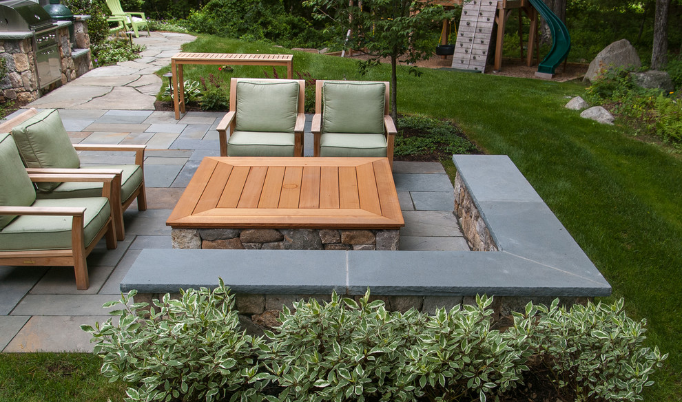 Photo of a small traditional backyard partial sun garden in Boston with a fire feature and natural stone pavers.