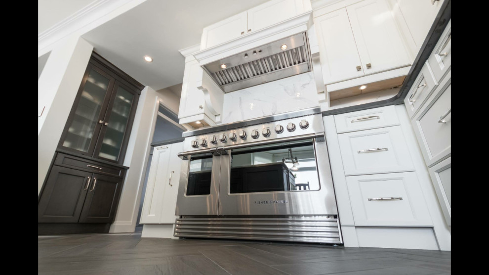 Enclosed kitchen - mid-sized transitional galley medium tone wood floor and brown floor enclosed kitchen idea in Ottawa with a double-bowl sink, recessed-panel cabinets, gray cabinets, granite countertops, porcelain backsplash, stainless steel appliances and gray countertops