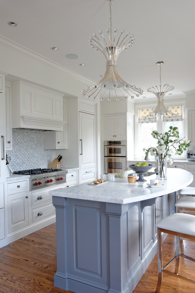 Photo of a mid-sized transitional u-shaped kitchen in Boston with an undermount sink, raised-panel cabinets, white cabinets, quartzite benchtops, grey splashback, stainless steel appliances, medium hardwood floors and with island.