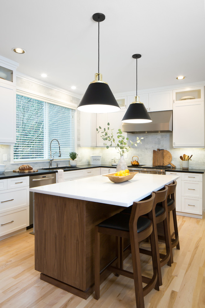 Mid-sized transitional l-shaped light wood floor and brown floor eat-in kitchen photo in Seattle with an undermount sink, shaker cabinets, white cabinets, quartz countertops, multicolored backsplash, marble backsplash, stainless steel appliances and an island