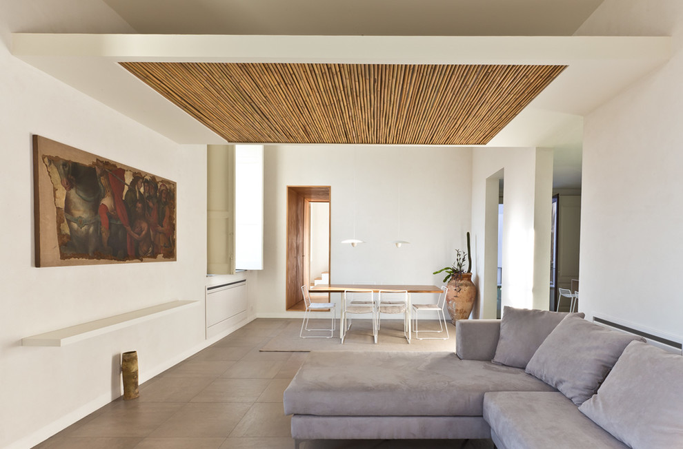 This is an example of a contemporary open concept living room in Rome.