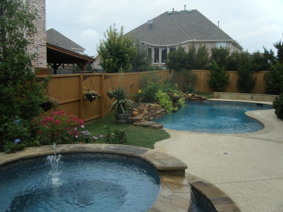 Inspiration for a large transitional backyard custom-shaped hot tub remodel in Dallas