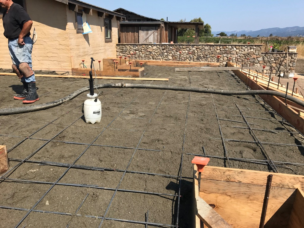 Patio Pour Prep with Stone Wall and Guest House Beyond