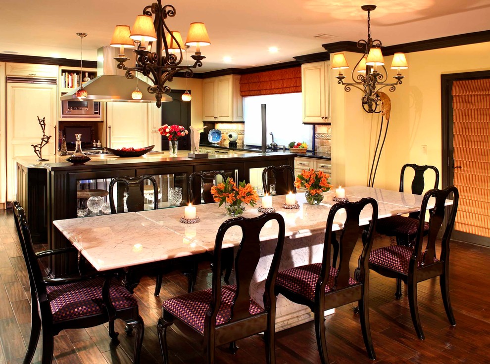 Traditional open plan dining in Los Angeles with multi-coloured walls and dark hardwood floors.