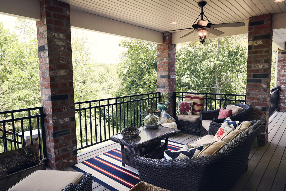 Inspiration for a large rustic backyard deck remodel with a roof extension
