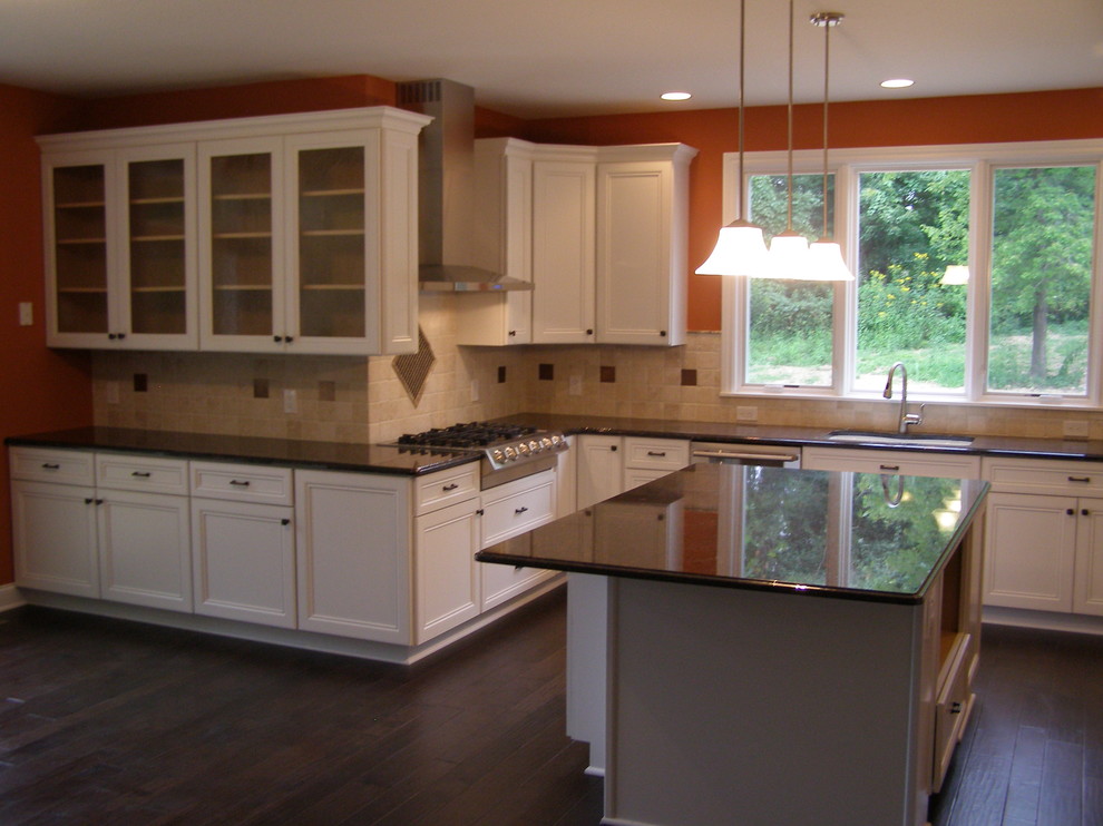 Large traditional u-shaped eat-in kitchen in Cleveland with an undermount sink, flat-panel cabinets, white cabinets, granite benchtops and with island.