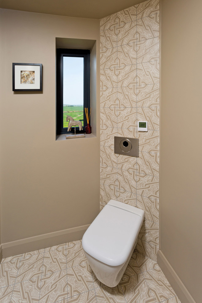 Photo of a small modern kids bathroom in Belfast with flat-panel cabinets, beige cabinets, a wall-mount toilet, beige tile, porcelain tile, beige walls and porcelain floors.