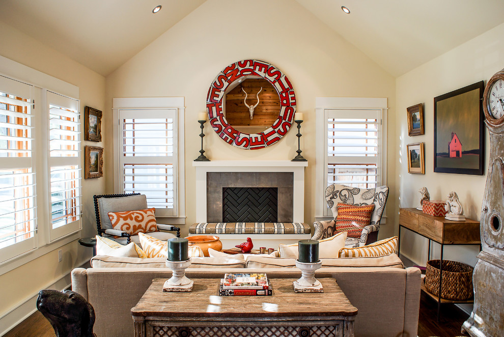 Inspiration for a traditional family room in Austin with beige walls, dark hardwood floors and a standard fireplace.