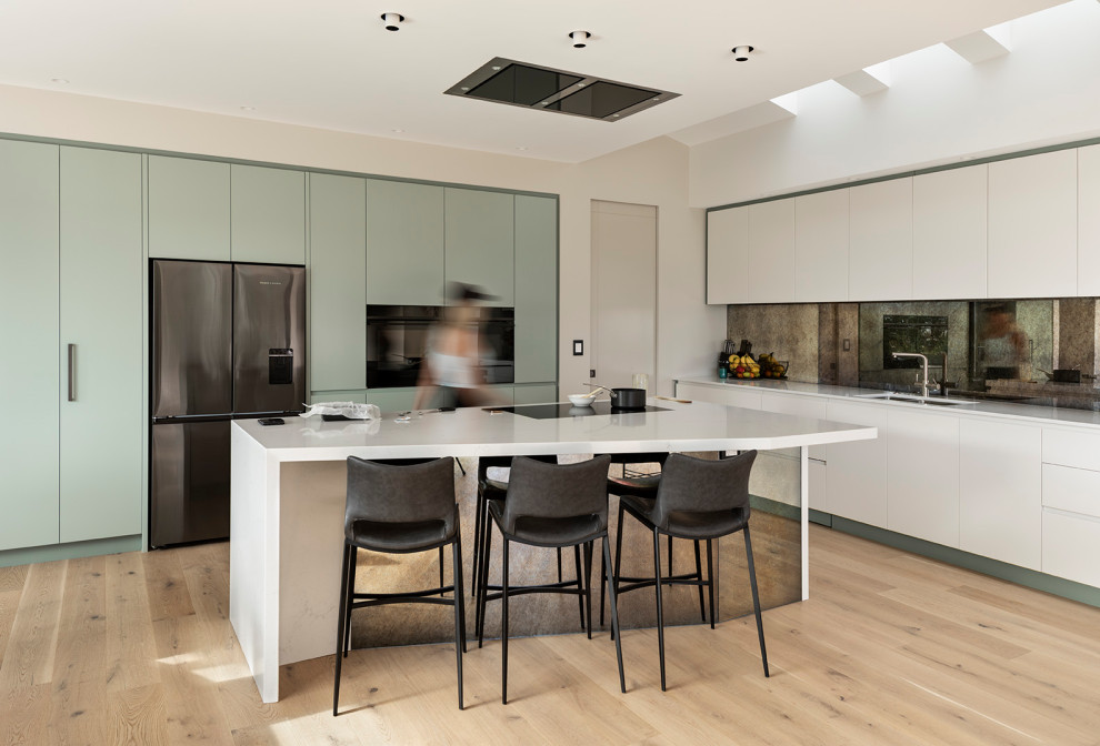 This is an example of a beach style kitchen in Auckland with with island.