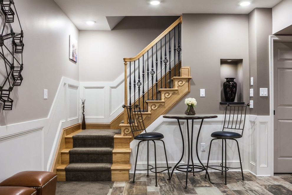 Basement - large rustic walk-out ceramic tile and multicolored floor basement idea with gray walls