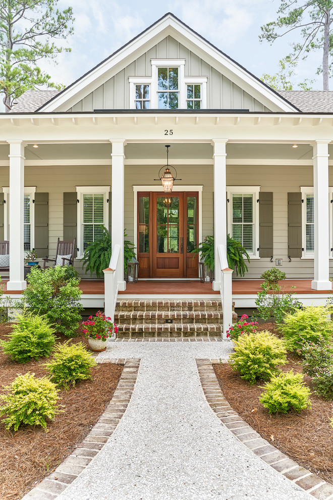 Coastal gray two-story house exterior idea in Charleston with a shingle roof