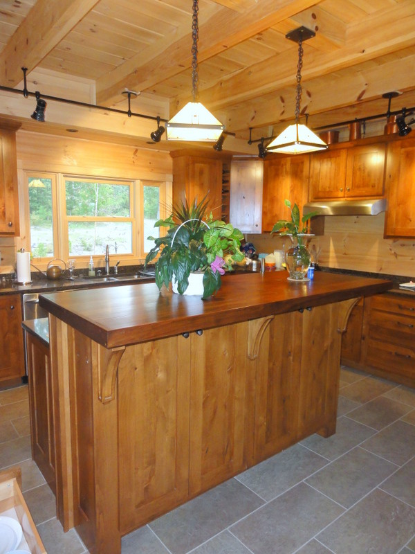 Inspiration for a rustic ceramic tile kitchen remodel with light wood cabinets, wood countertops, an island and shaker cabinets