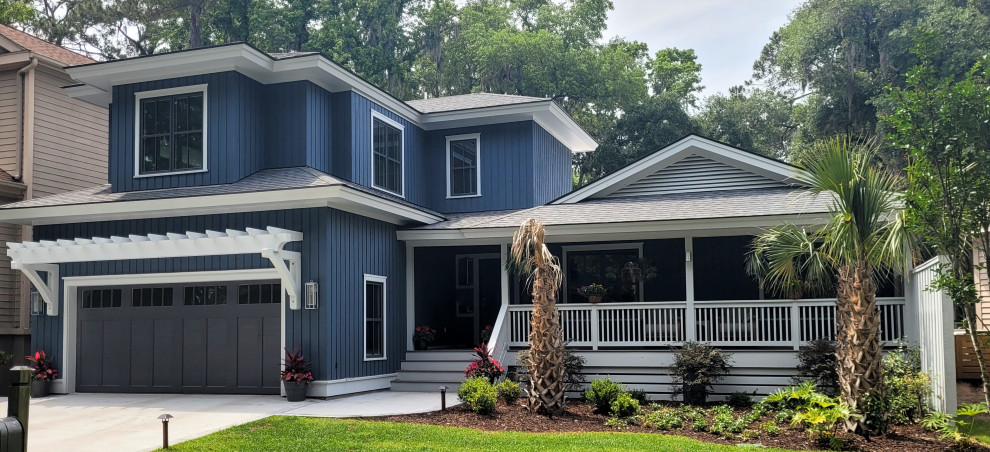 This is an example of a medium sized and blue beach style two floor detached house in Other with concrete fibreboard cladding, a hip roof, a shingle roof, a grey roof and board and batten cladding.