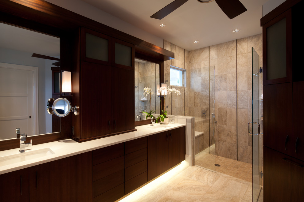 Design ideas for a mid-sized contemporary master bathroom in Miami with an undermount sink, dark wood cabinets, an alcove shower, beige tile, flat-panel cabinets, limestone benchtops, limestone floors and limestone.