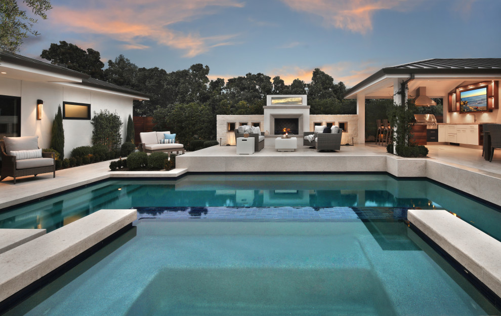 Design ideas for a contemporary pool in Orange County with a hot tub.