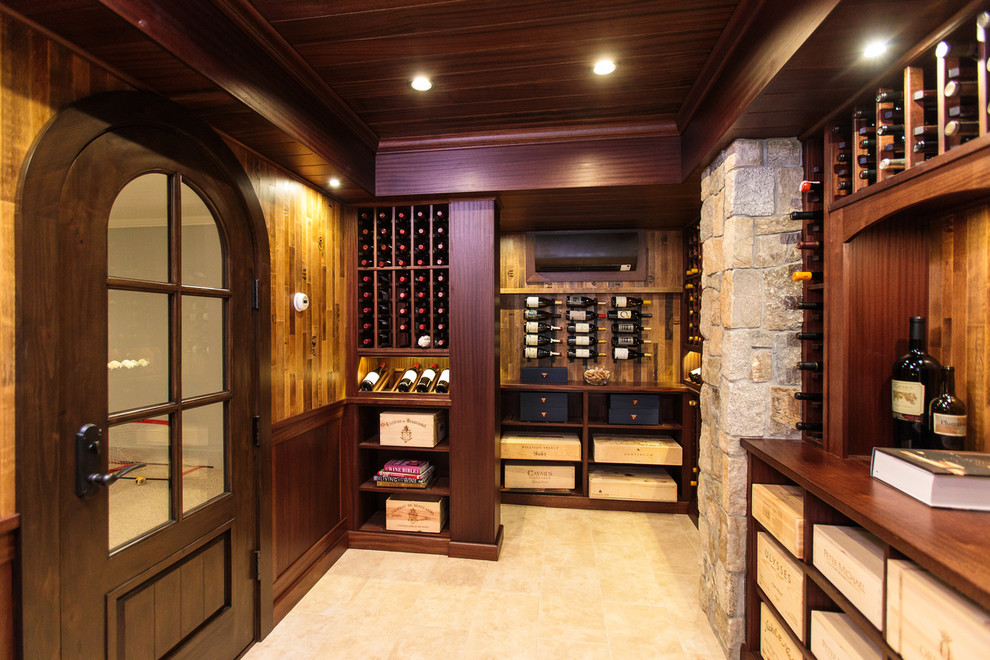 This is an example of a traditional wine cellar in Boston with travertine floors, storage racks and beige floor.