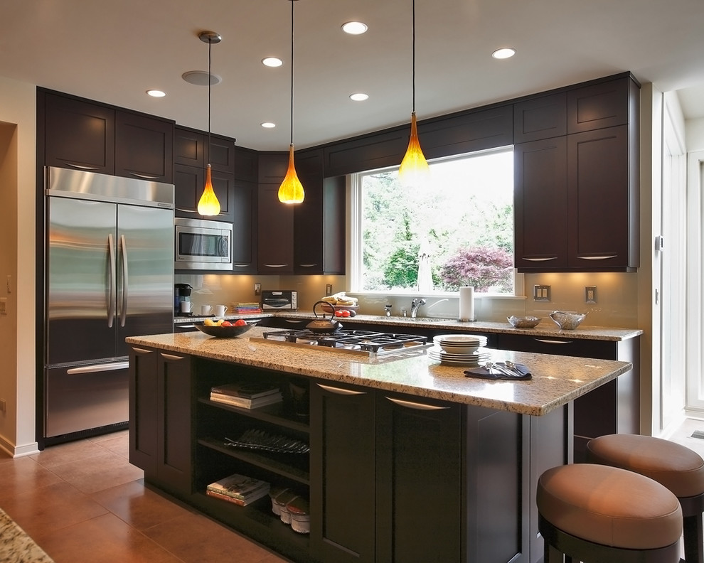 Inspiration for a large transitional u-shaped eat-in kitchen in DC Metro with an undermount sink, recessed-panel cabinets, dark wood cabinets, granite benchtops, stainless steel appliances, ceramic floors and with island.