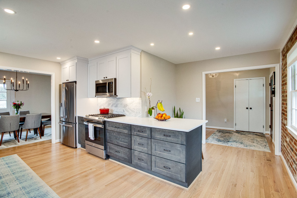 Example of a small transitional single-wall kitchen design in DC Metro with a farmhouse sink, quartz countertops, stainless steel appliances and a peninsula