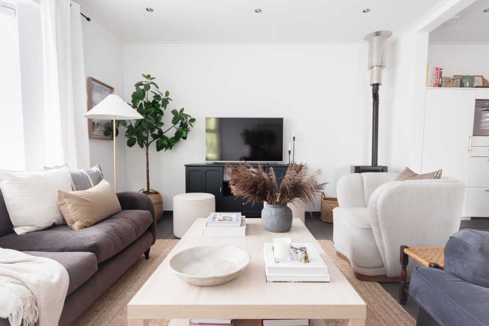 Large traditional open plan living room curtain with white walls, ceramic flooring, a corner fireplace, a freestanding tv, black floors and curtains.
